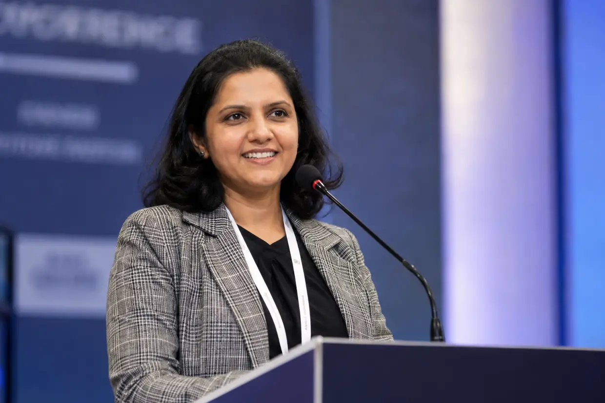 Dr. Kalpa Pandya, oral and maxillofacial surgeon, speaking at a medical conference podium